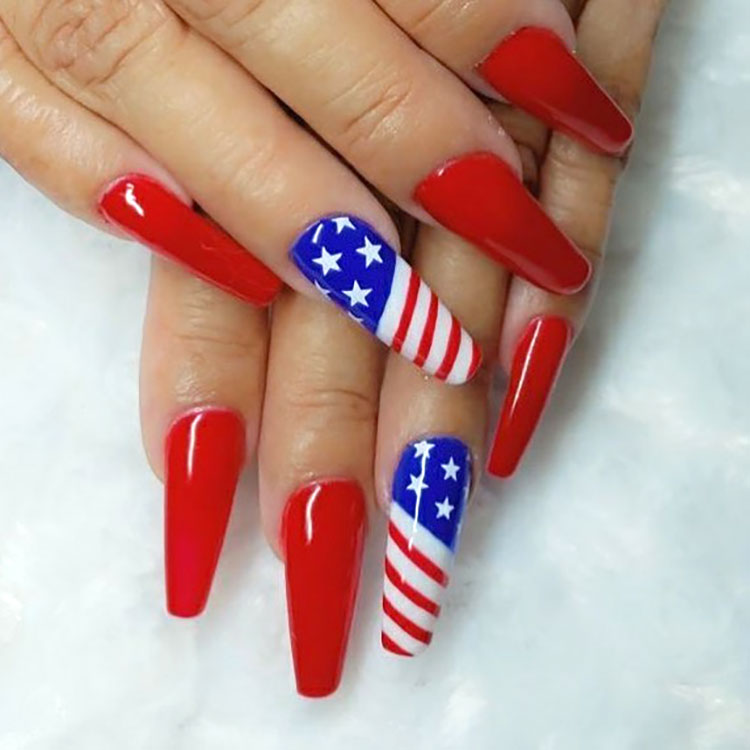 long ballerina-style nails painted red with an American flag accent nail