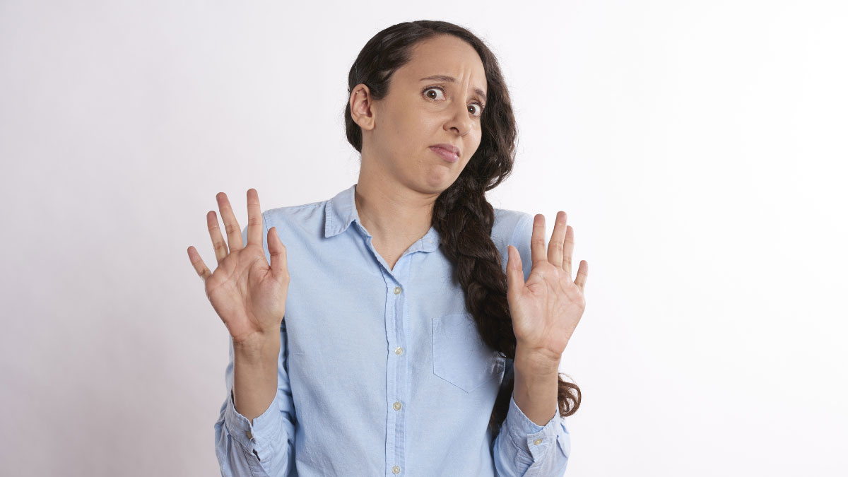 a woman holding her hands up in disgust and confusion