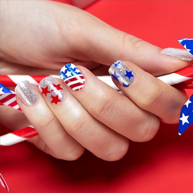 square nails painted silver featuring various top designs including American flags and stars
