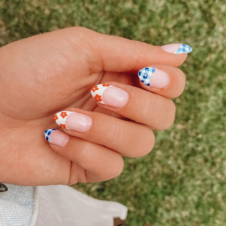 oval French tips, white with blue gingham and reddish-orange flower designs