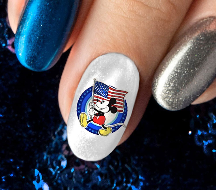 an oval-shaped silver nail with a decal featuring Mickey Mouse holding an American flag