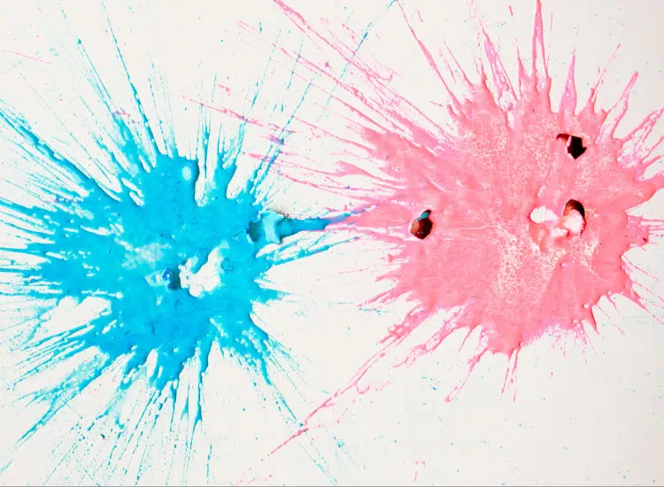 blue and pink paintball splatters on a white background