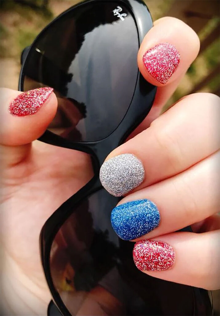dip nail polish done in red, blue, and silver glitter