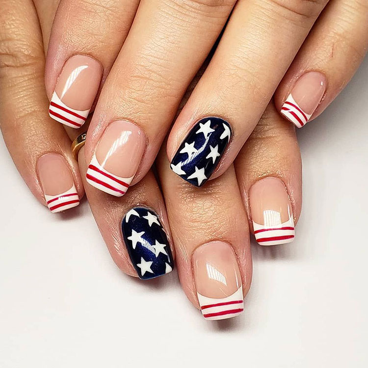squoval French tips, white with red stripes, with a navy accent nail featuring white stars