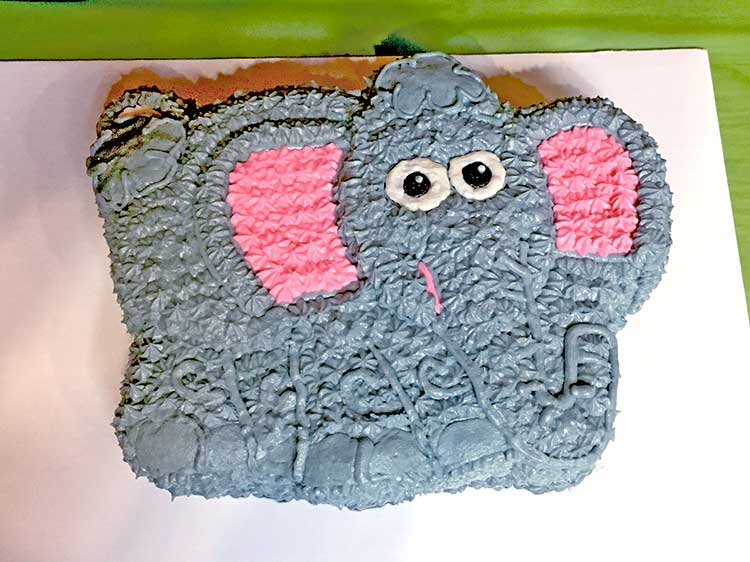 a homemade buttercream cake made to look like a baby elephant