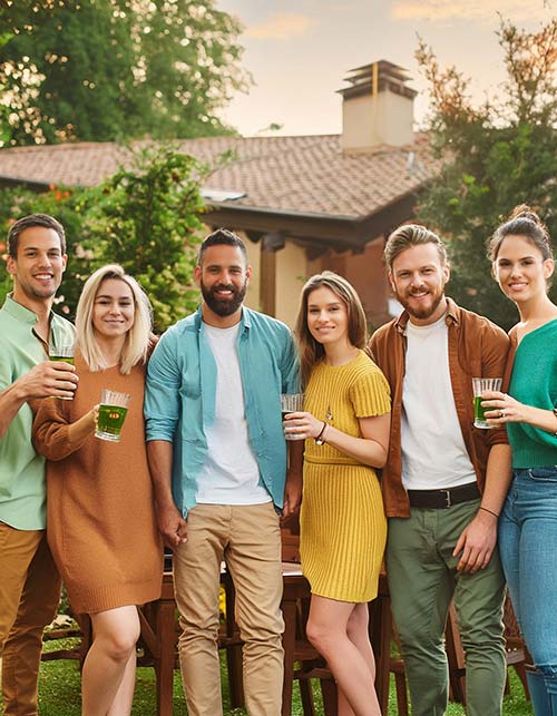 a group of young adults all dressed in muted yellow, brown, green, and blue colors