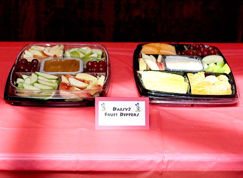 two fruit trays with a card that reads "Daisy's Fruit Dippers"