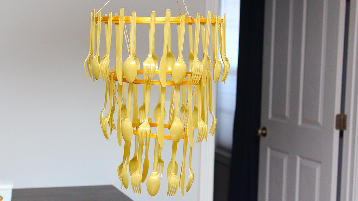 a homemade gold cutlery chandelier that is reminiscent of Beauty and the Beast