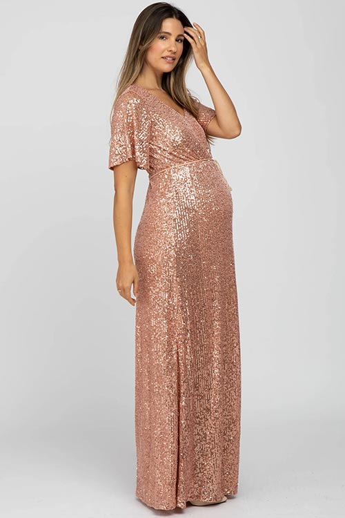 pregnant woman in sequined rose-gold maxi dress