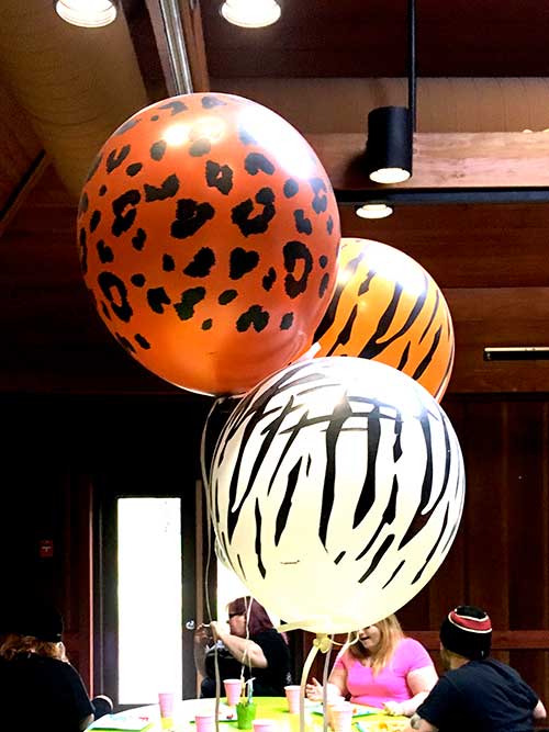 floating animal-print balloons (cheetah, tiger, and zebra)