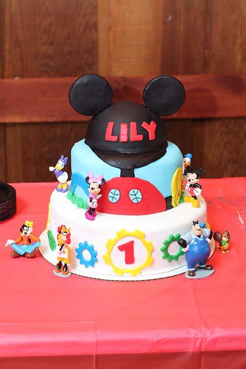 a homemade three-tier Mickey Mouse Clubhouse fondant birthday cake