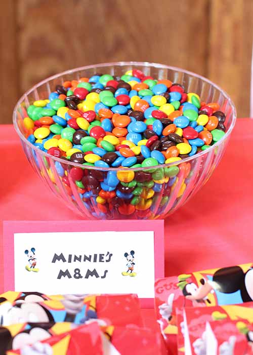 a large bowl of M&Ms and a card that says "Minnie's M&Ms"