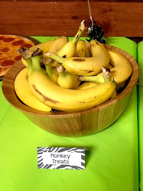bananas in a bowl with a food card labeled "Monkey Treats"