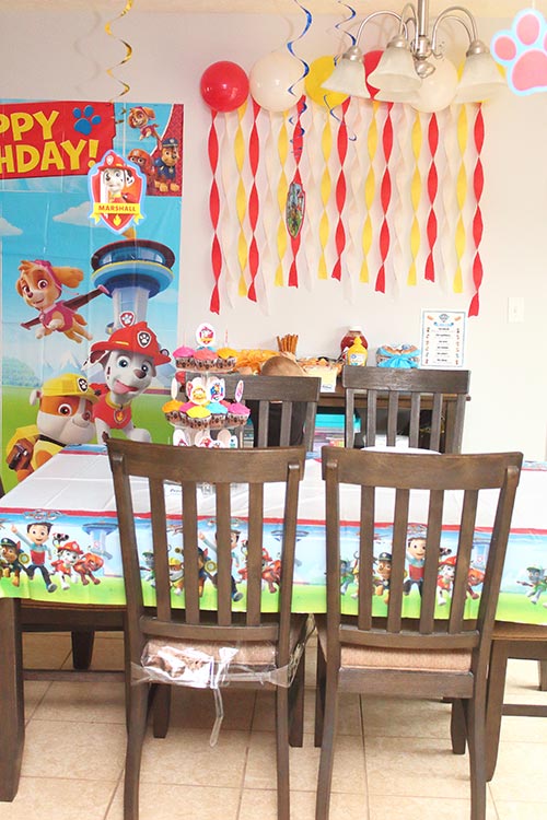 a home kitchen fully decorated for a Paw Patrol birthday party