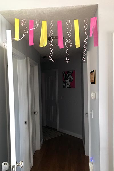 pink and yellow garland hanging over a hallway entrance