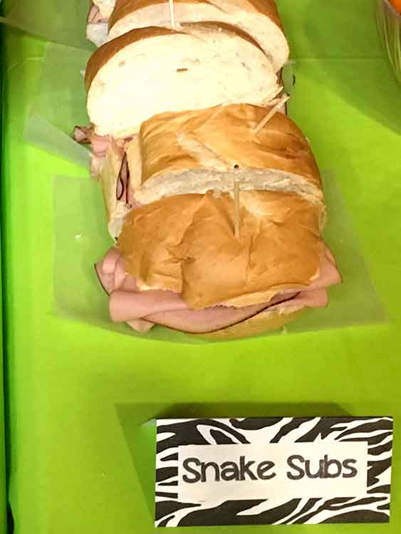 ham and cheese sub sandwiches with a food card labeled "Snake Subs"