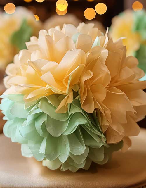 pom pom made from pale green and pale yellow tissue paper