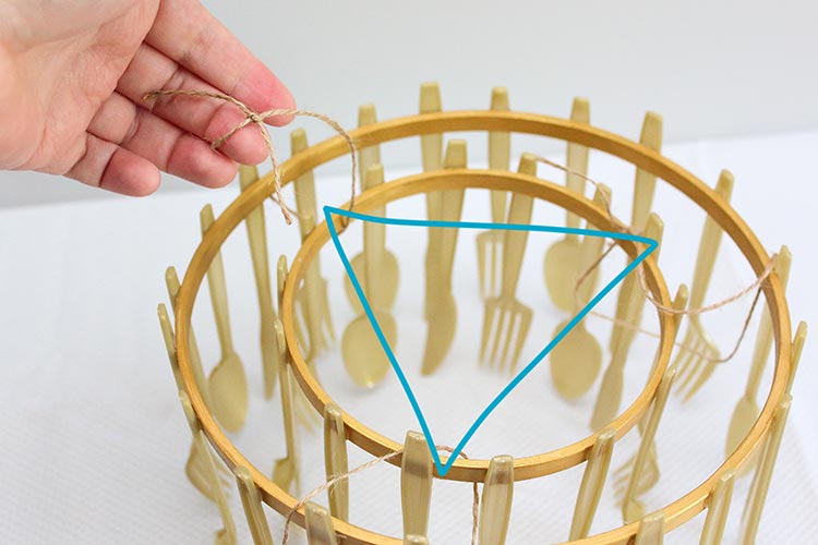 an illustration of twine loops forming a triangle to connect two chandelier tiers