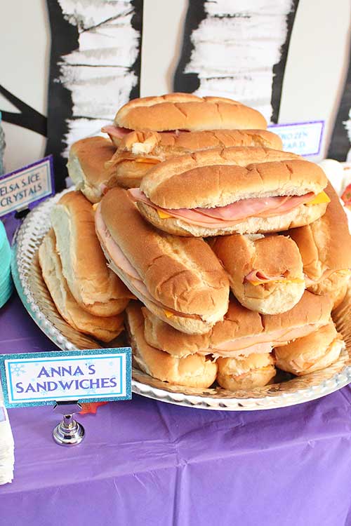 a platter of ham and cheese hoagies labeled "Anna's Sandwiches"