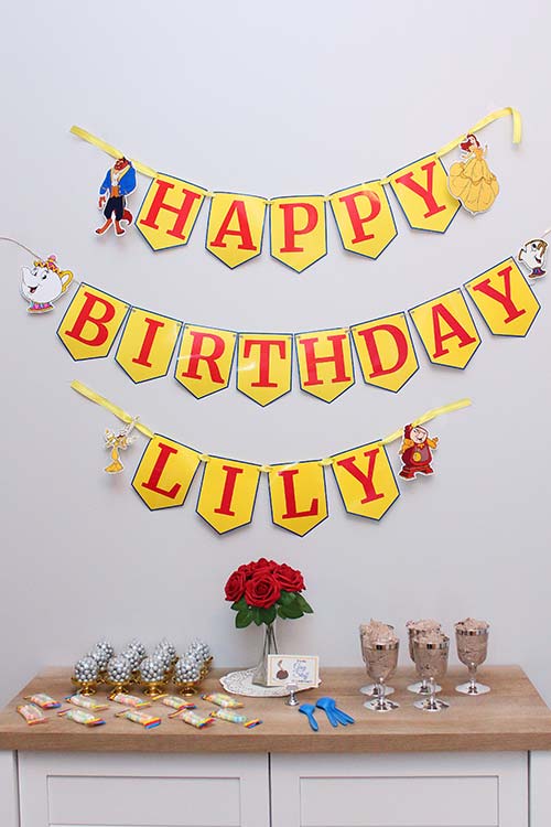 a homemade Beauty and the Beast-themed happy birthday banner