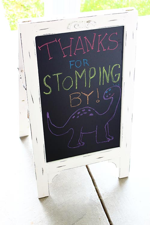 a chalkboard that says "Thanks for STOMPING By!" with a brontosaurus drawn under it