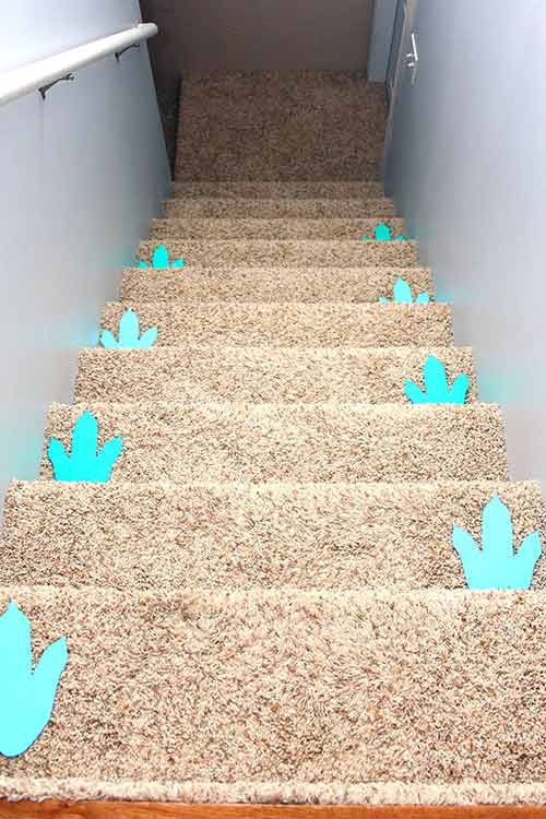 blue dinosaur footprints going down a staircase