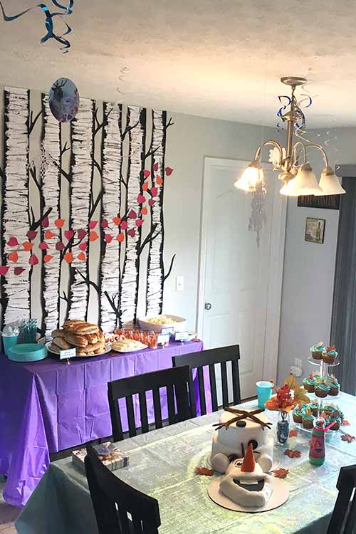 a kitchen table and buffet area decorated for a Frozen birthday party