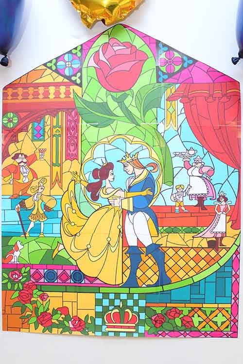 a printed and pieced together wall decoration of the final stained glass window design from Beauty and the Beast where Belle and the prince are dancing together