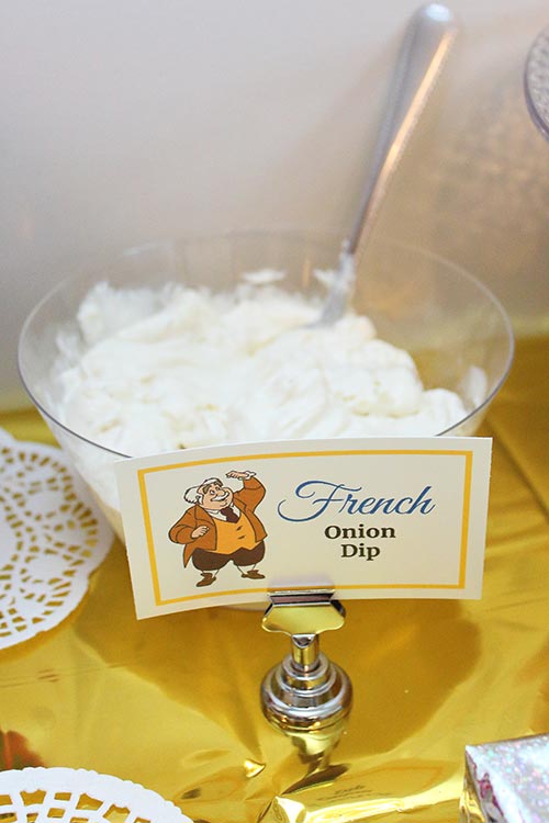 a bowl of French onion dip with a food card featuring Maurice from Beauty and the Beast