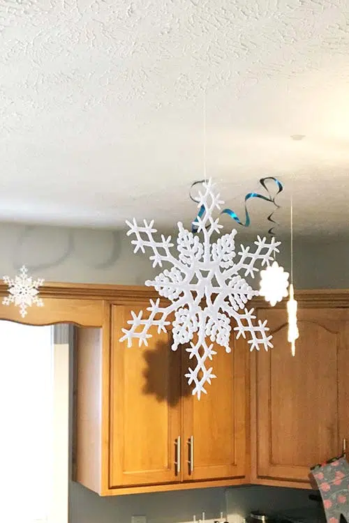 faux snowflakes hanging from a ceiling