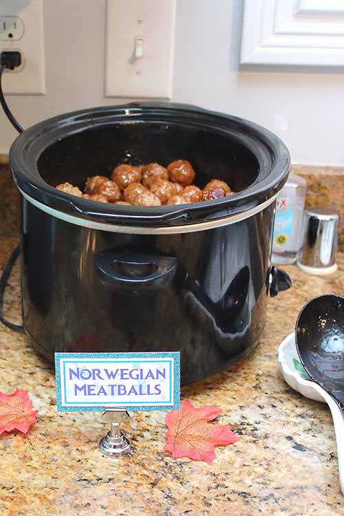 a crockpot full of BBQ meatballs labeled "Norwegian meatballs"