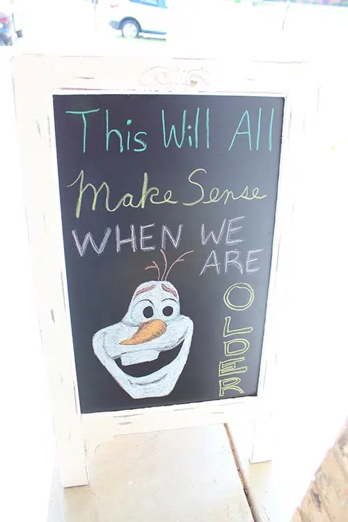 a chalkboard sign that says "This will all make sense when we are older" with Olaf from Frozen drawn at the bottom