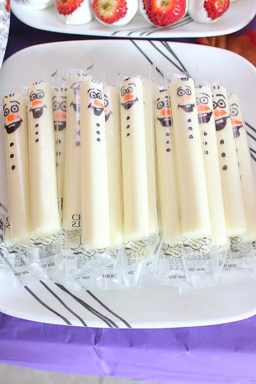 a plate of wrapped mozzarella cheese sticks with Olaf drawn on each one