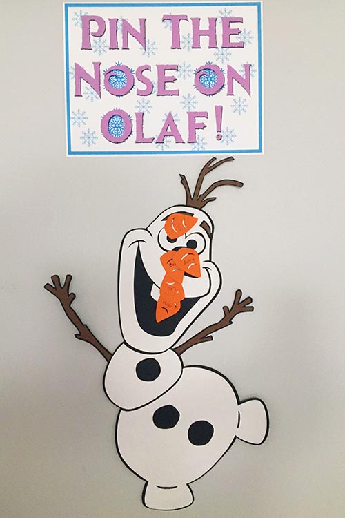 a homemade Pin the Nose on Olaf game covered in carrot noses