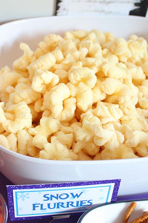 bowl of white cheddar puffcorn labeled "snow flurries"