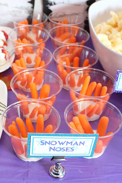 cups of baby carrots in ranch labeled "snowman noses"