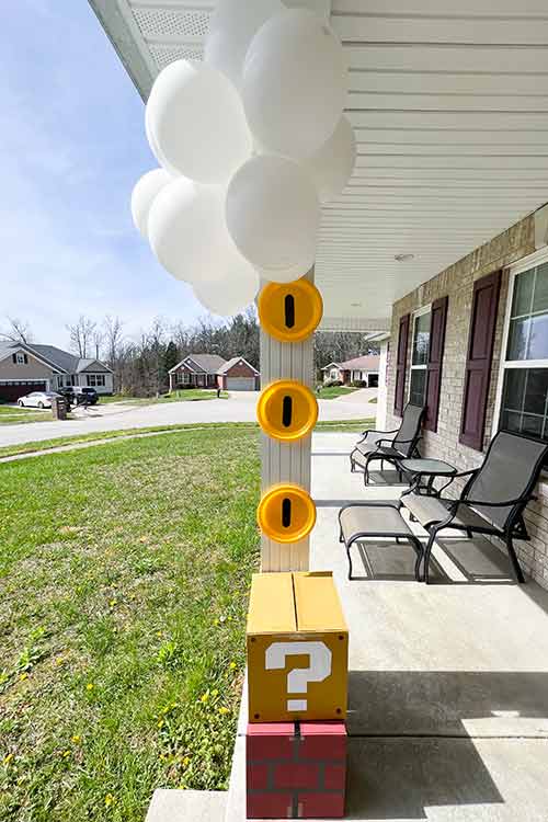 homemade Mario coins and blocks on a porch column