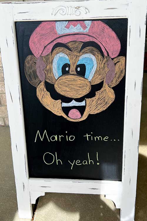 a Mario-themed chalkboard welcome sign