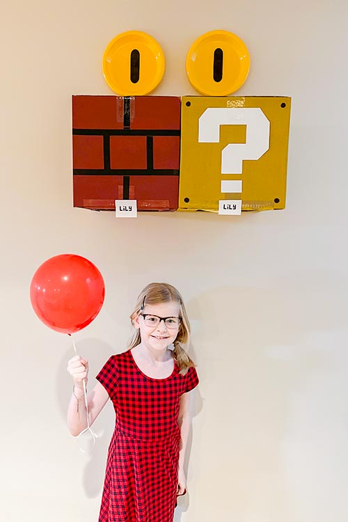 little girl standing under DIY Mario bricks