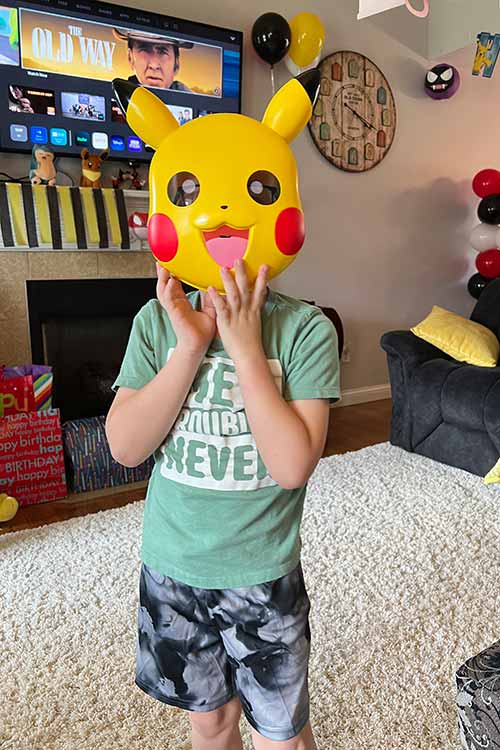 a boy wearing a Pikachu mask