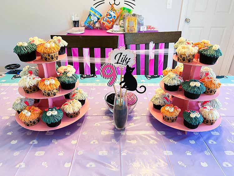 cat cupcakes and a homemade centerpiece between them