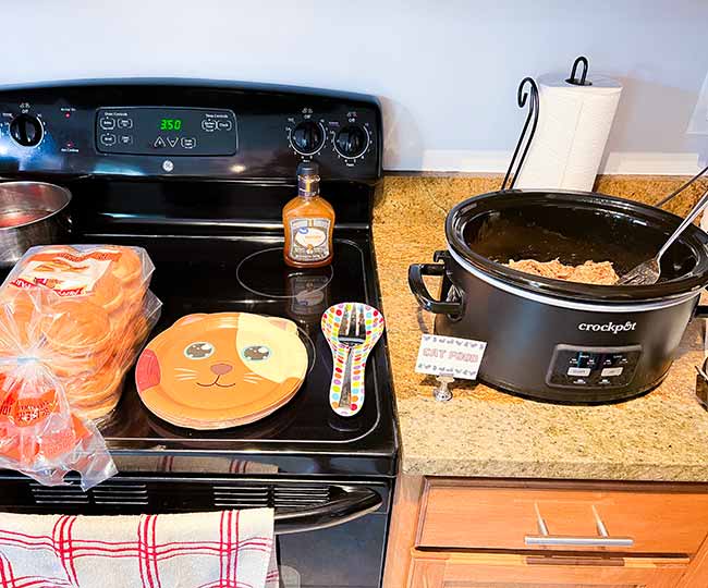 pulled pork and plates on a kitchen counter