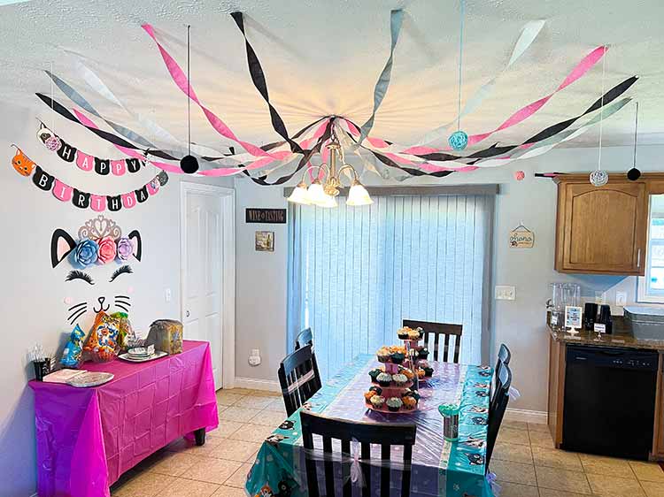 a kitchen decorated for a cat-themed birthday party