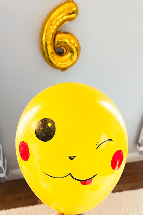 a yellow balloon with a Pikachu face