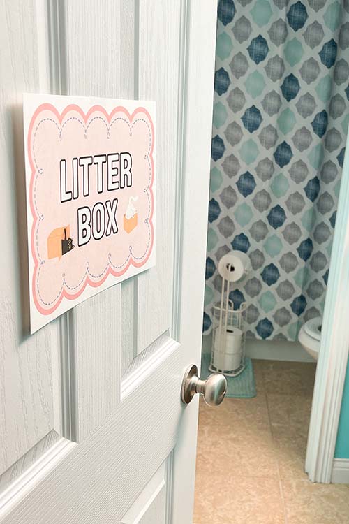 a bathroom door labeled "Litter Box"