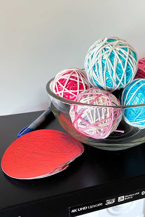 a stack of printed paper balls of yarn