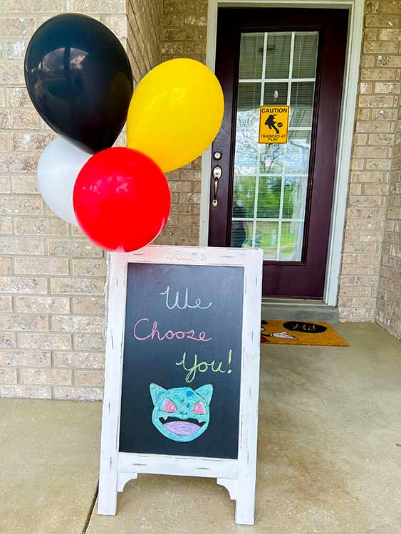 a chalkboard with balloons attached