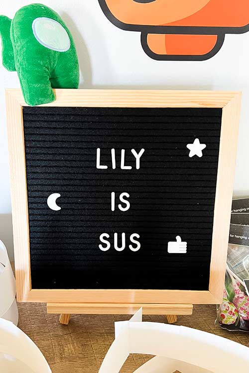 a letter board that says "Lily is Sus"