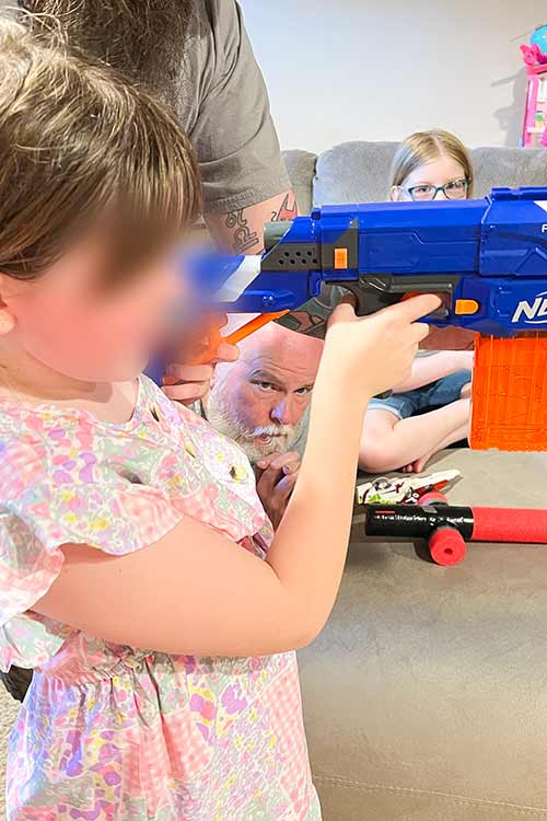 a girl holding a Nerf gun