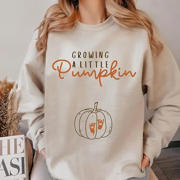 pumpkin-themed pregnancy reveal sweatshirt